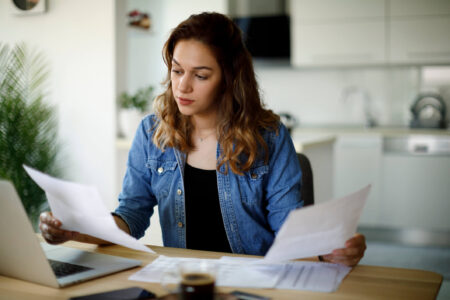woman preparing a paper tax return
