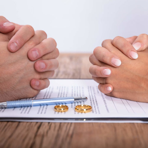 couples hands clenched discussing divorce and taxes