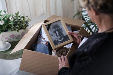 woman looking at a photo and wondering how to file a tax return for a deceased taxpayer