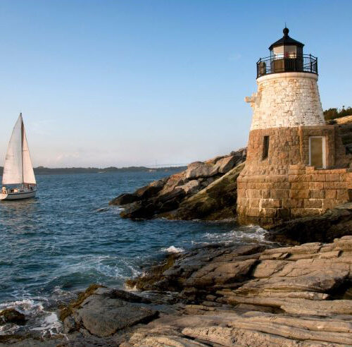 Rhode Island state taxes - sailboat by lighthouse