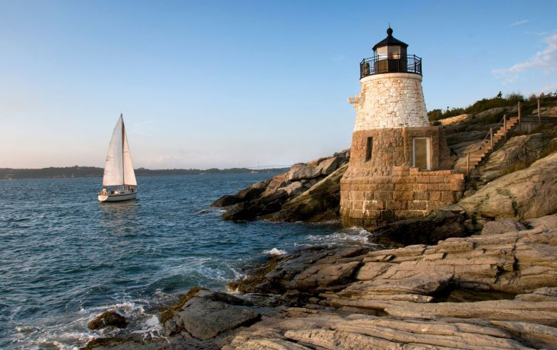 Rhode Island state taxes - sailboat by lighthouse