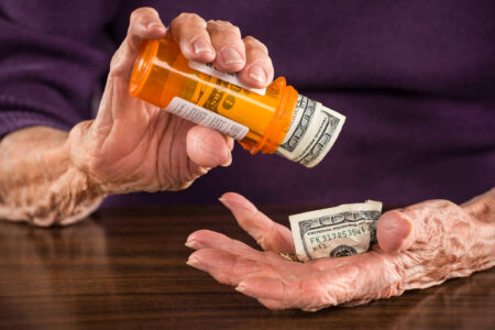 can you deduct medical expenses from taxes - person shaking money from pill bottle