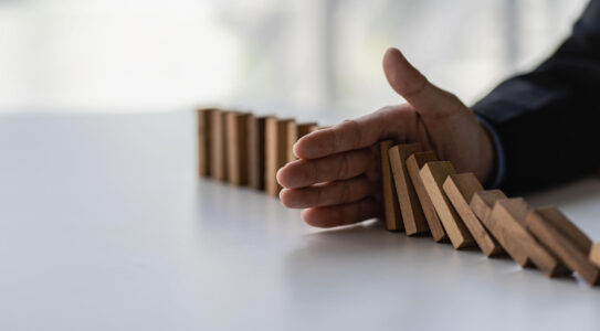 hand halting tumbling blocks representing stopping an irs tax levy