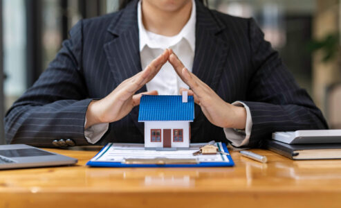 irs agent with hands over house - tax lien subordination