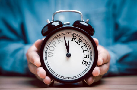 Hombre sosteniendo un reloj de jubilación