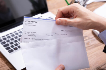 person looking at payckeck wondering what taxes were deducted