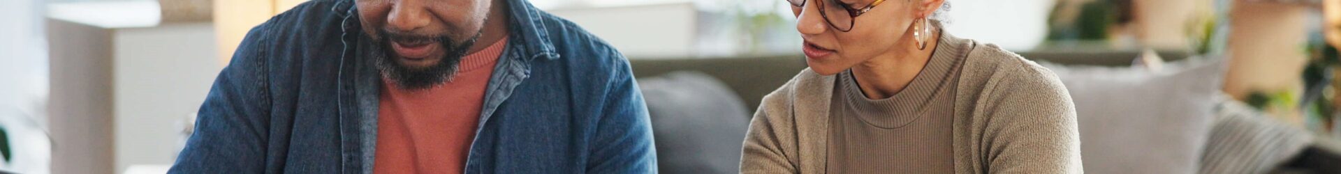 couple preparing a paper tax return