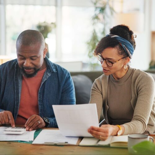 couple preparing a paper tax return