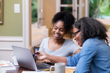 mother and adult child reviewing taxes