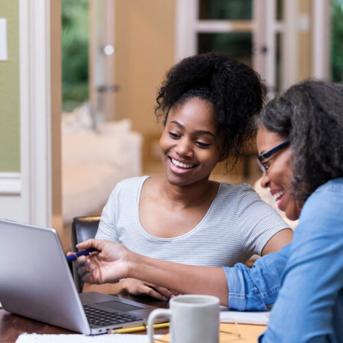 mother and adult child reviewing taxes